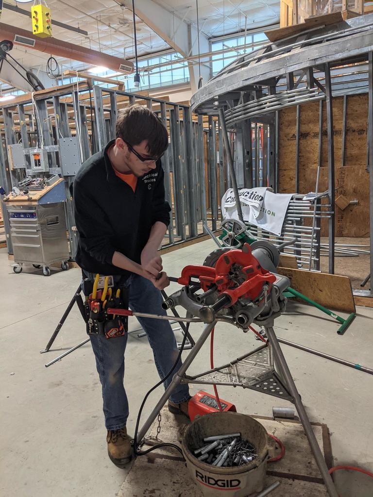 male electrical student cutting