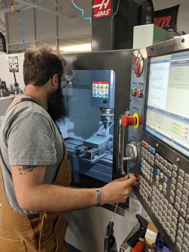 male working on CNC machine