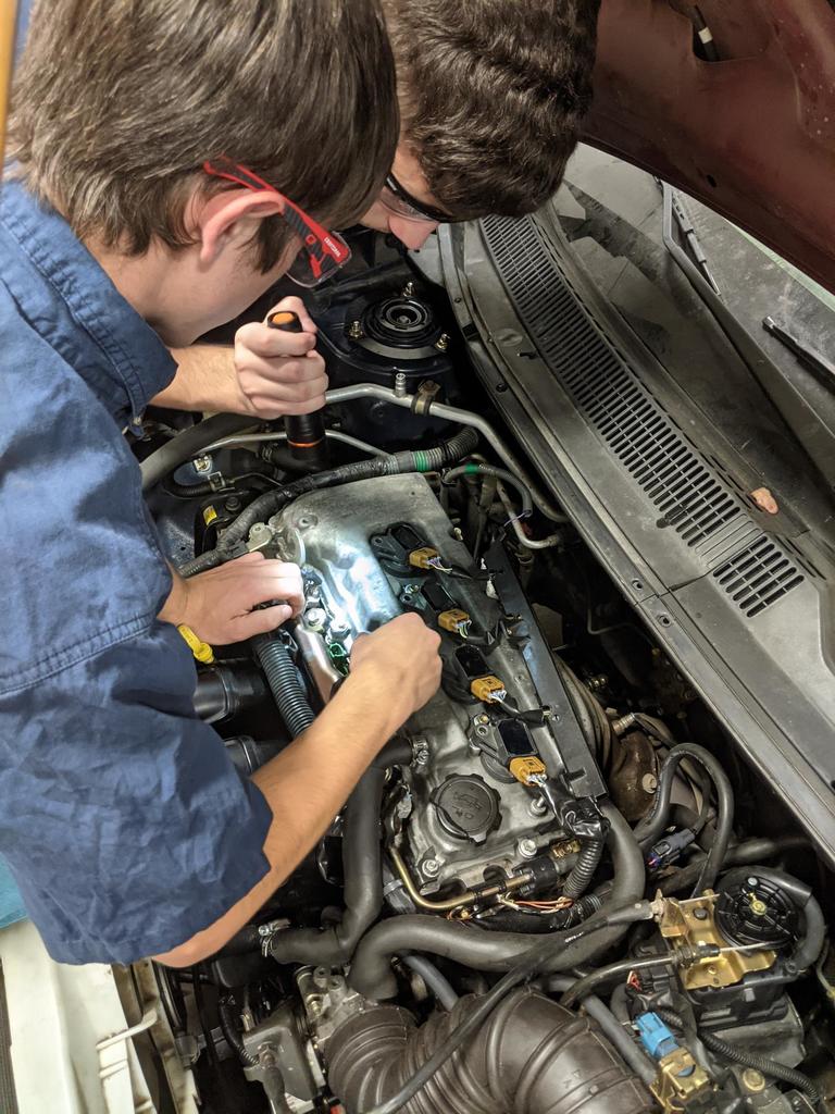 students working on an engine