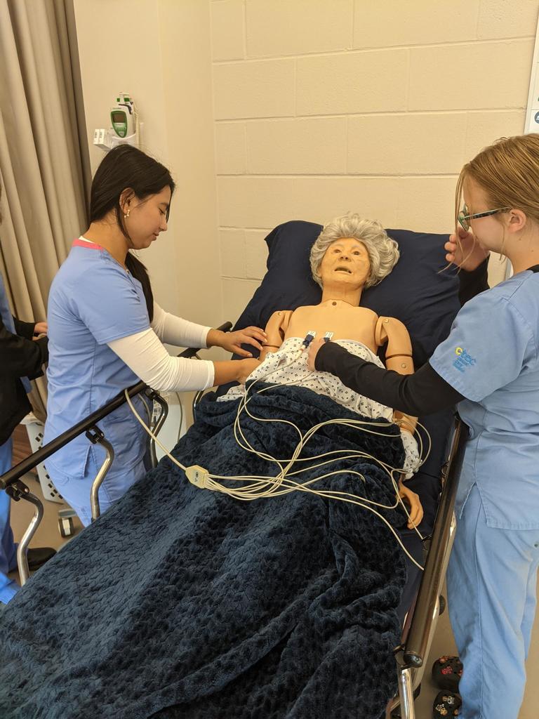 Clinical care students with dummy