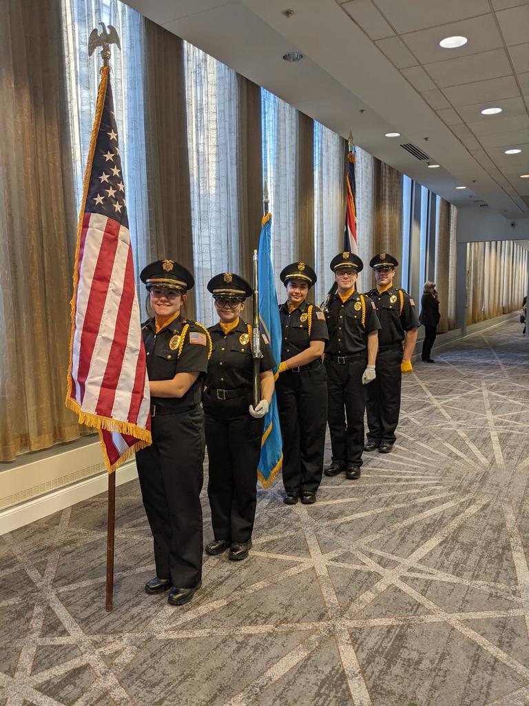 Color guard students standing in line holding the American flag